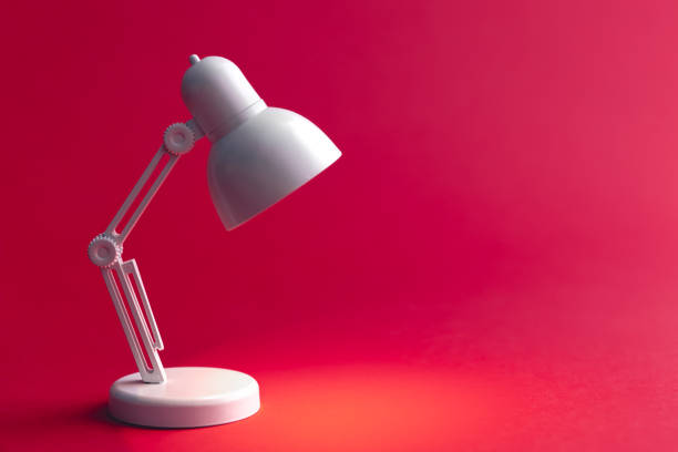 White table lamp on a Viva Magenta background, copy space.