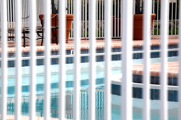 Pool Fence the fence around a swimming pool pool gate stock pictures, royalty-free photos & images