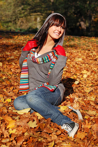 istock Beautiful brunette seating among the leaves 147333509