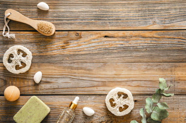 istock Spa composition with body care items on wooden background, top view. 1473335425