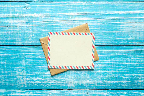 istock Envelope and postcard for text on a blue wooden background, top view. 1473335662
