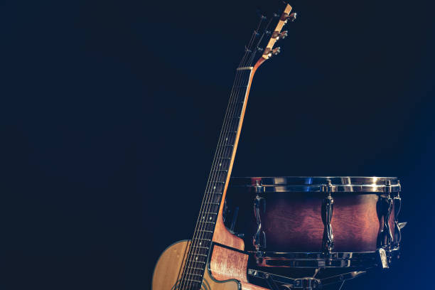 istock Acoustic guitar and snare drum on a black background isolated. 1473337493