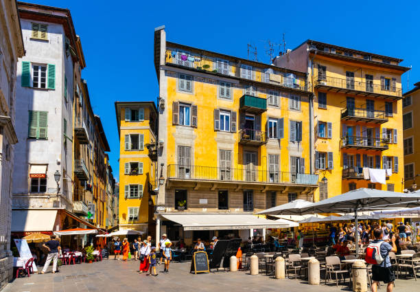 colorful tenement houses at place rossetti square in vieille ville historic old town of nice on french riviera in france - city of nice restaurant france french riviera imagens e fotografias de stock