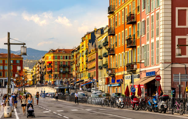 colorful tenement houses along quai des docks street in historic nice port district on french riviera in france - city of nice restaurant france french riviera imagens e fotografias de stock