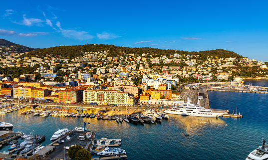 Nice, France - July 30, 2022: Nice Port and yacht marina district sunset panorama with Mont Boron hill at French Riviera of Mediterranean Sea Harbor