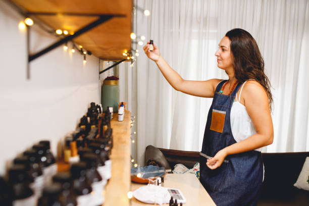 istock Brazilian woman perfumer working in her workshop, choosing essential oils 1473343484