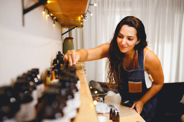 istock Brazilian woman perfumer working in her workshop, choosing essential oils 1473343523