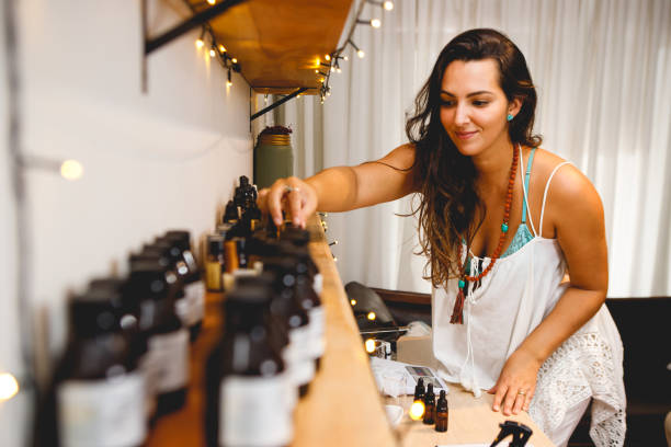 istock Brazilian woman perfumer working in her workshop, choosing essential oils 1473343526