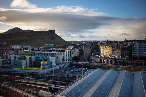 Locked off time lapse of Edinburgh on a spring day, looking across the roof of Waverley Station towards the Old Town, Salisbury Crags and Arthur's Seat. This still image is part of a series, a time lapse video is also available.
