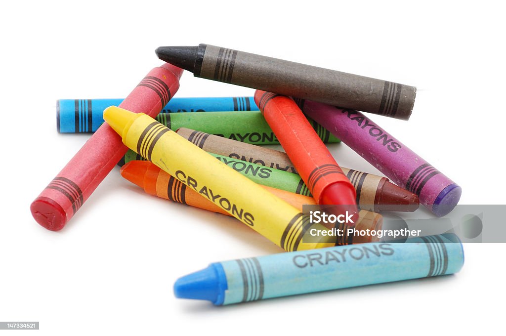 A number of multicolored crayons piling on top of each other Crayons lying in chaos isolated on white backgrond Crayon Stock Photo