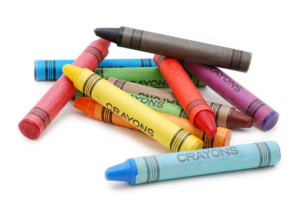 A number of multicolored crayons piling on top of each other Crayons lying in chaos isolated on white backgrond crayon stock pictures, royalty-free photos & images