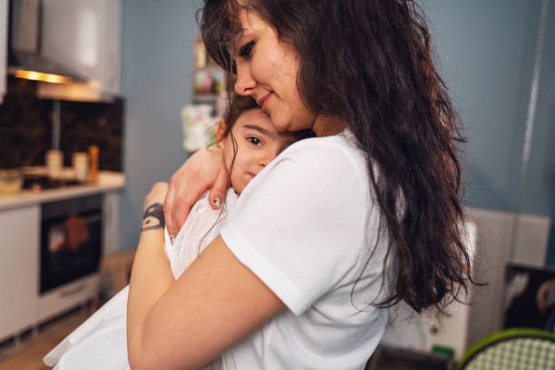 istock Smiling mother embracing her daughter 1473348941