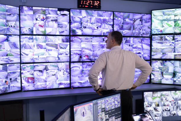 istock Man working in surveillance room and looking at camera 1473350527