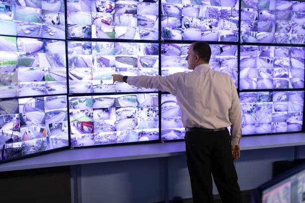 istock Man working in surveillance room and looking at camera 1473350563
