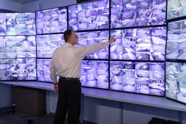 istock Man working in surveillance room and looking at camera 1473350583
