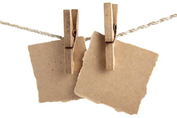 Craft note paper pinned with a vintage clothespin on a rope on a white background. Design mockup