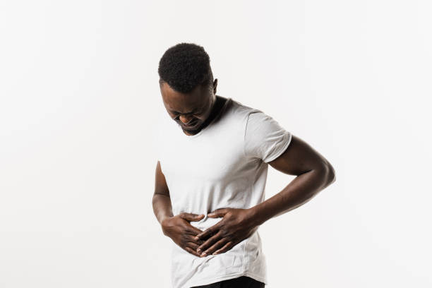 Sick african american man hold abdomen because it hurts. Stomach pain. Pancreatitis disease of pancreas becomes inflamed. Sick african american man hold abdomen because it hurts. Stomach pain. Pancreatitis disease of pancreas becomes inflamed endometriosis bloated stock pictures, royalty-free photos & images