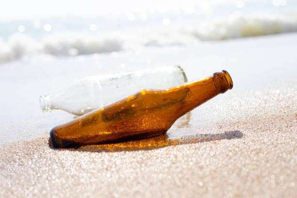 istock Glass bottles on the beach 1473361887