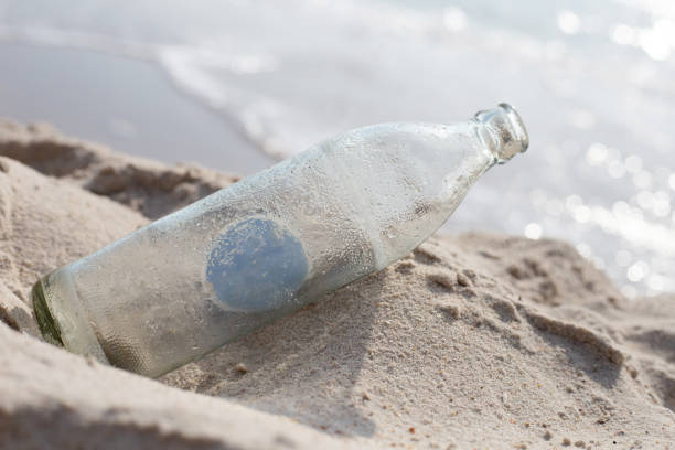 istock Glass bottle on the beach 1473361901