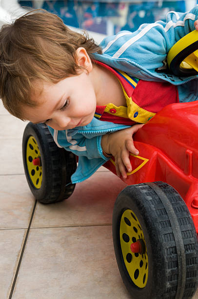 A two-year-old Asian child is playing.