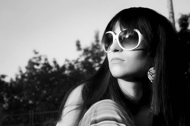 Young woman looking in sun stock photo