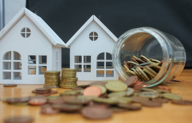istock euro coins and houses on the table 1473368448