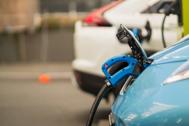istock Charge pump in a blue electric car. 1473371998