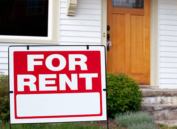 For Rent Sign In Front of House stock photo