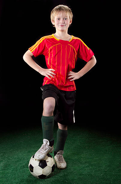 istock Happy soccer kid on grass with ball 147337340