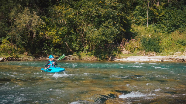 istock Male kayaker paddling over the whitewater rapids 1473373616