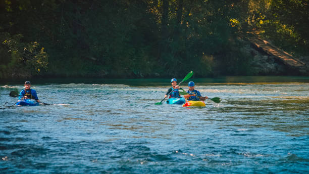 istock Kayakers paddling and maneuvering on the river, going under the bridge 1473373815