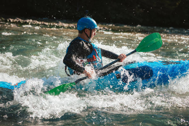 istock Male kayaker paddling over the whitewater rapids 1473373912