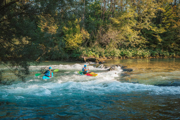 istock Kayakers paddling and maneuvering on the river, going under the bridge 1473373981