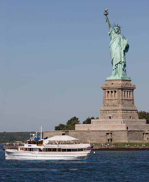 istock Statue of Liberty and cruise boat 147337416
