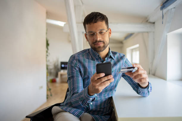 istock Man using her credit card to shop online 1473377787