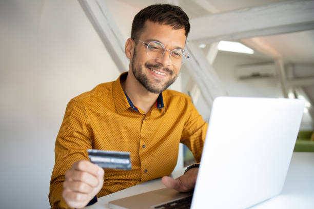istock Man using her credit card to shop online 1473377819