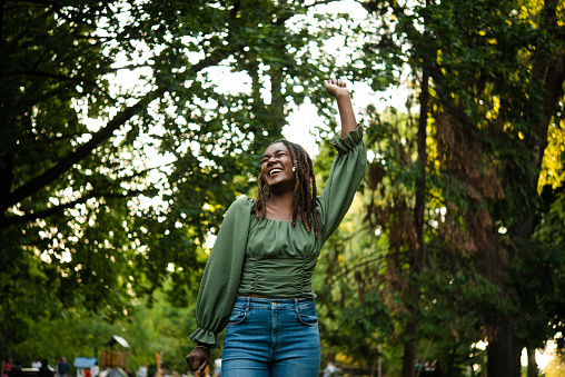 Portrait of a beautiful, young African American woman enjoying in the park