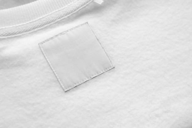 blank white laundry care clothes label on fabric texture background - scale industry copy space special imagens e fotografias de stock