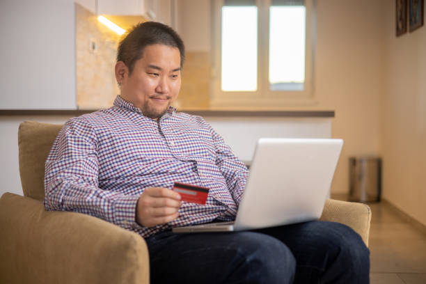 istock Happy young customer enjoys shopping online 1473379301