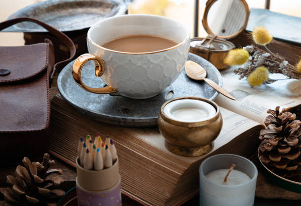 istock Hot coffee in ceramic cup and brass coffee spoon served with Fresh milk on worktable. 1473380539