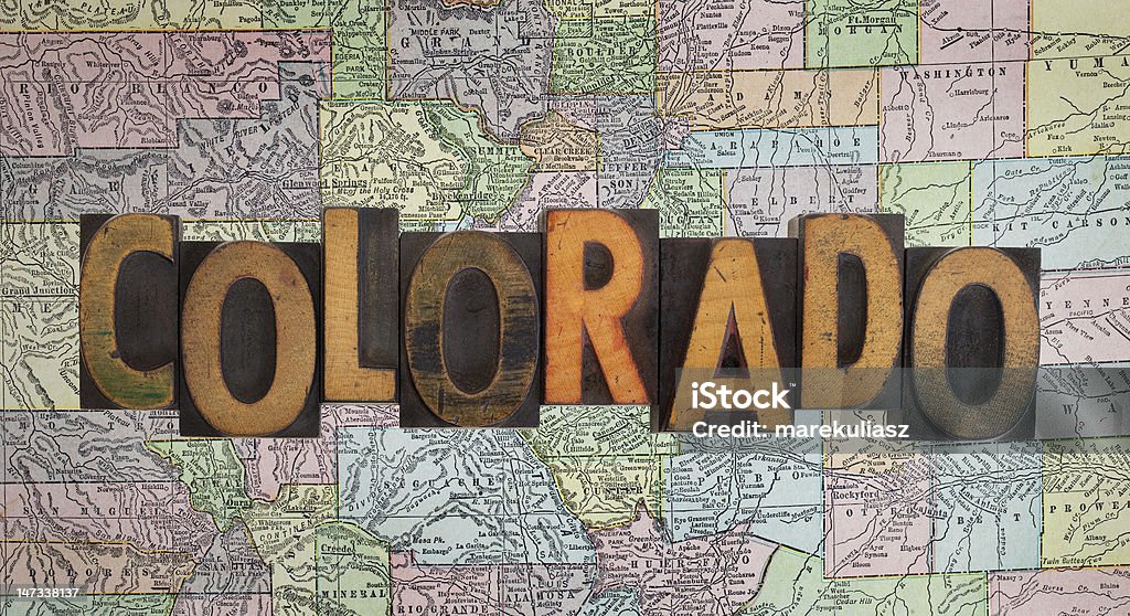 vintage Colorado map word Colorado in antique letterpress wooden type stained by ink over a vintage (eighty years old) faded map of the state Antique Stock Photo