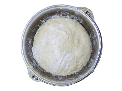 Ready dough for baking in a pan. Raw thick dough. Before making pies. Kneaded yeast dough. Unprepared. calorie product