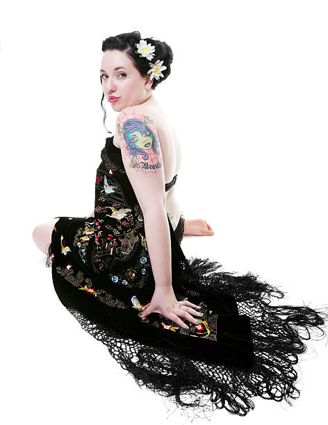 Rockabilly Goddess Beautiful rockabilly girl draped in a gorgeously embroidered black velvet shawl.  Shot on white background. black pin up girl tattoos stock pictures, royalty-free photos & images