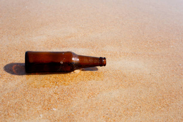 istock Glass bottle on the beach 1473385666