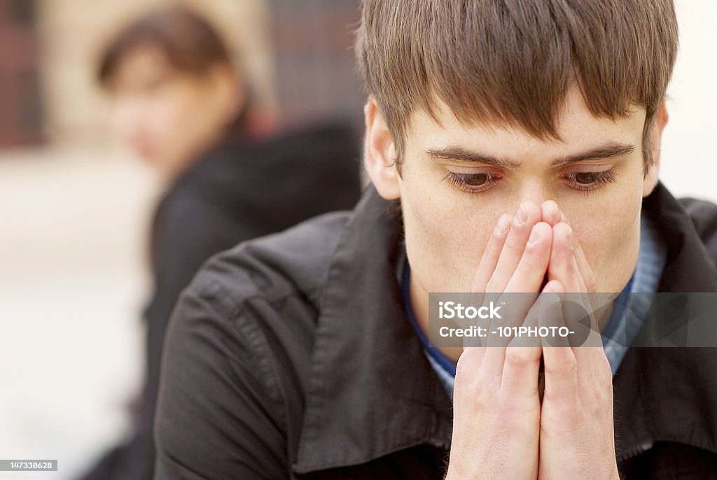 Angry couple sitting on bench Angry couple sitting on bench in city. Adult Stock Photo