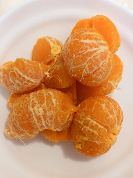 istock Peeled Mandarin Oranges in a White Bowl 1473399179