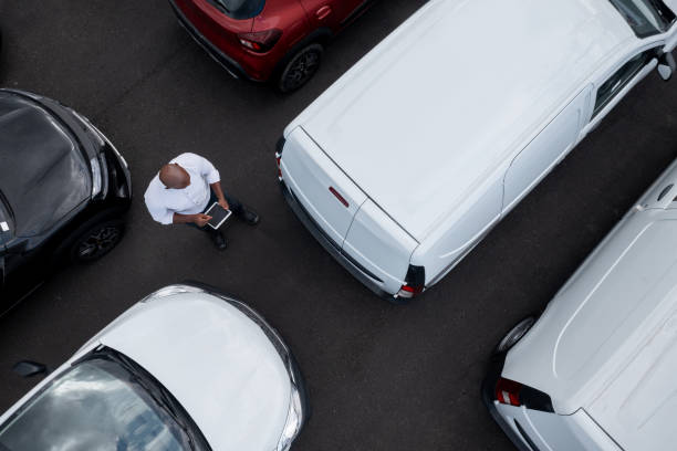 salesman working at the dealership selling cars - fleet of vehicles imagens e fotografias de stock