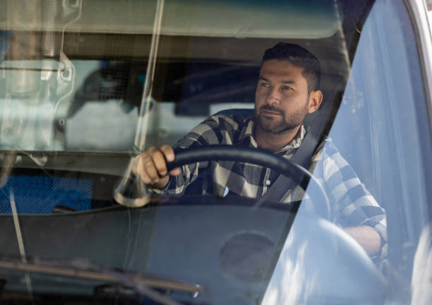 istock Truck driver driving his cargo vehicle 1473399430
