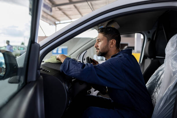 istock Worker polishing a car while working at a car wash 1473399460