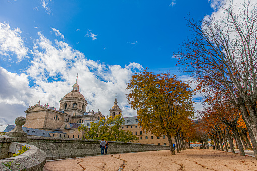 Peak fall colors adorn the vast open spaces of the El Escorial, Spain.